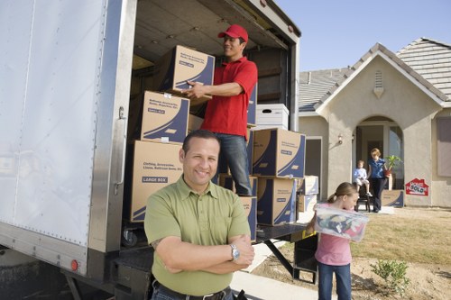 Local movers handling furniture in a Streatham home