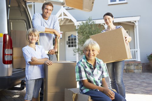 Local removals team handling furniture in a Streatham residential street