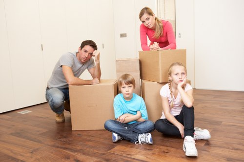 Packed moving boxes and furniture ready for transport in Streatham